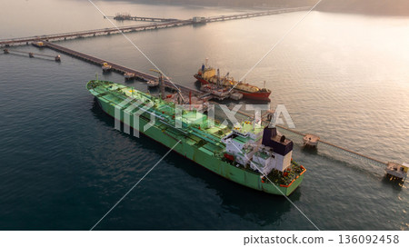 Aerial view LPG tanker ship at oil and gas terminal platform, Liquefied Petroleum Gas tanker ship industrial oil gas terminal tanker ship, LPG tanker ship loading and unloading petrochemical industry. Aerial view LPG tanker ship at oil and gas terminal platform, Liquefied Petroleum Gas tanker ship industrial oil gas terminal tanker ship, LPG tanker ship loading and unloading petrochemical industry. 136092458