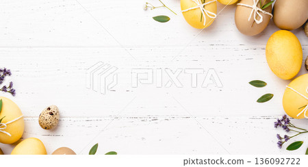 Easter eggs with flowers on a white table. Easter eggs with flowers on a white table. 136092722