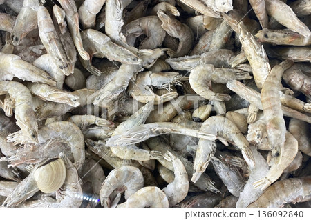 Close-up of a large pile of frozen raw shrimp and clams Close-up of a large pile of frozen raw shrimp and clams 136092840