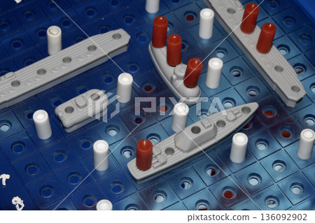 Close up of strategic battleships board game with ships and pegs Close up of strategic battleships board game with ships and pegs 136092902