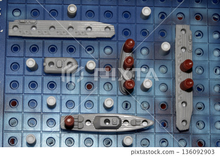 Close up of strategic battleships board game with ships and pegs Close up of strategic battleships board game with ships and pegs 136092903