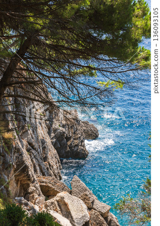 A dramatic seaside scene featuring rugged limestone cliffs 136093105