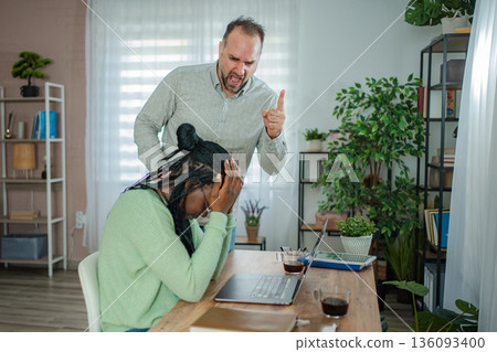 Boss yelling at crying employee experiencing workplace harassment Boss yelling at crying employee experiencing workplace harassment 136093400