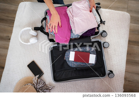 Woman packing suitcase for summer vacation trip Woman packing suitcase for summer vacation trip 136093568