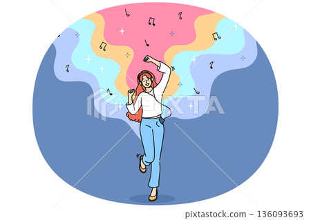 Teenage woman listens to music on headphones and dances rhythmically with hands, and uses phone Teenage woman listens to music on headphones and dances rhythmically with hands, and uses phone 136093693