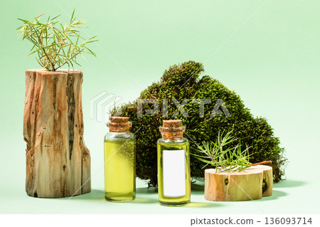 Healthy juniper product Essential juniper oil bottles with natural elements on green background Healthy juniper product Essential juniper oil bottles with natural elements on green background 136093714