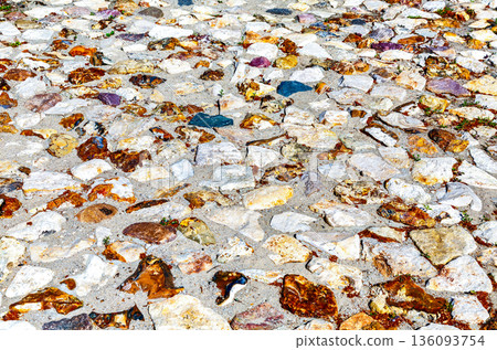 Rough cobblestone pavement on the road as creative background texture. Natural stones as background Rough cobblestone pavement on the road as creative background texture. Natural stones as background 136093754
