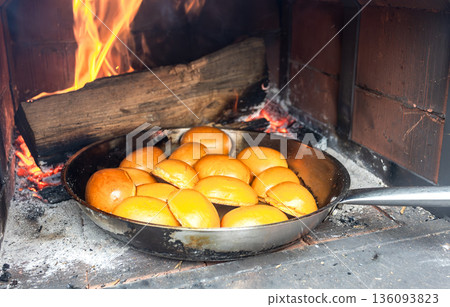 Delicious pies are baked in a frying pan in a traditional Russian oven 136093823