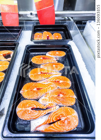 Steaks of fresh salmon fish on the counter. Raw red fish for sale. Seafood shop Steaks of fresh salmon fish on the counter. Raw red fish for sale. Seafood shop 136093855