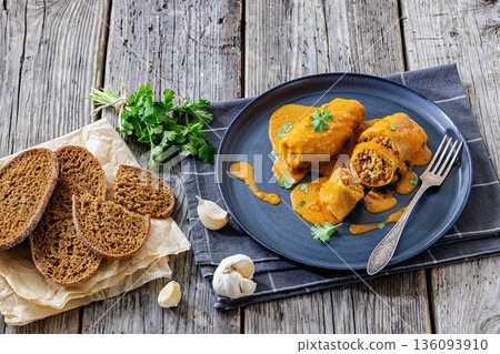 Stuffed cabbage rolls with quinoa and tomato sauce Stuffed cabbage rolls with quinoa and tomato sauce 136093910