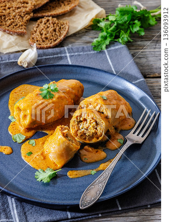 Stuffed cabbage rolls with quinoa and tomato sauce Stuffed cabbage rolls with quinoa and tomato sauce 136093912