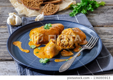 Stuffed cabbage rolls with quinoa and tomato sauce Stuffed cabbage rolls with quinoa and tomato sauce 136093913