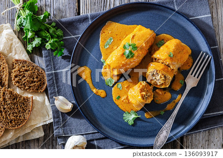 Stuffed cabbage rolls with quinoa and tomato sauce Stuffed cabbage rolls with quinoa and tomato sauce 136093917