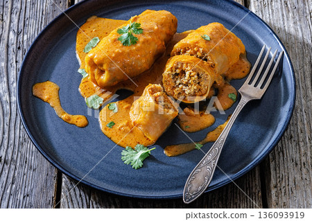 Stuffed cabbage rolls with quinoa and tomato sauce Stuffed cabbage rolls with quinoa and tomato sauce 136093919