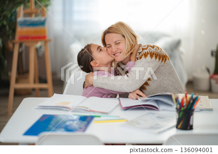 Mother and daughter bonding during homework time Mother and daughter bonding during homework time 136094001