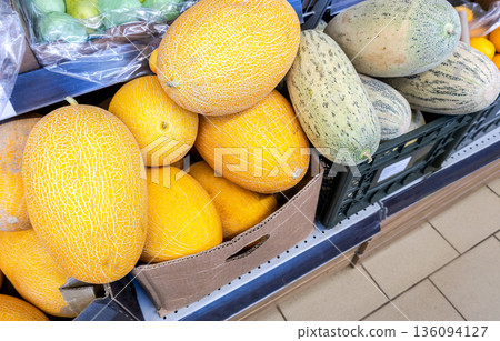 Fresh melons are sold at the grocery store Fresh melons are sold at the grocery store 136094127