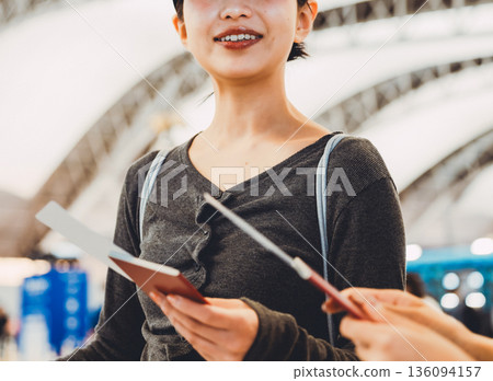 A woman presenting her documents at the airport. Photo courtesy of Kansai International Airport (KIX) A woman presenting her documents at the airport. Photo courtesy of Kansai International Airport (KIX) 136094157