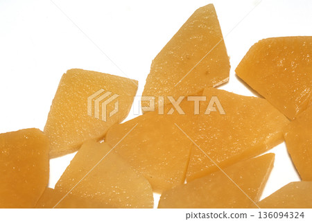 Close up of sliced pickled sweed root vegetables healthy food preperation orange on white backgroun Close up of sliced pickled sweed root vegetables healthy food preperation orange on white backgroun 136094324