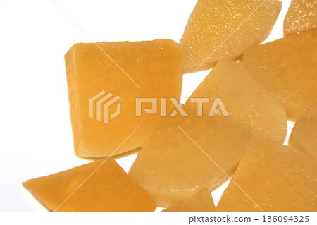 Close up of sliced pickled sweed root vegetables healthy food preperation orange on white backgroun 136094325