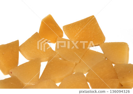 Close up of sliced pickled sweed root vegetables healthy food preperation orange on white backgroun Close up of sliced pickled sweed root vegetables healthy food preperation orange on white backgroun 136094326