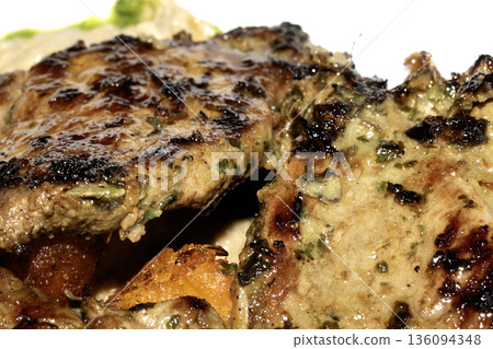 Close up of roasted marinated lamb and potatoes meal dinner on white background Close up of roasted marinated lamb and potatoes meal dinner on white background 136094348