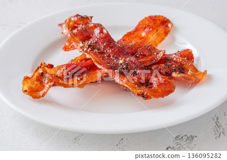 Stacked billionaire bacon slices with caramelized glaze pepper and chili flakes 136095282