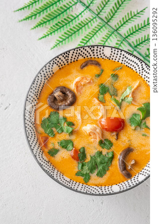 Creamy tom yum soup with shrimp coconut milk and herbs 136095292