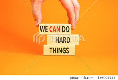 Support, help we can do hard things symbol. Concept words We can do hard things on beautiful wooden blocks. Beautiful orange background. Business we can do hard things concept. Copy space. Support, help we can do hard things symbol. Concept words We can do hard things on beautiful wooden blocks. Beautiful orange background. Business we can do hard things concept. Copy space. 136095533