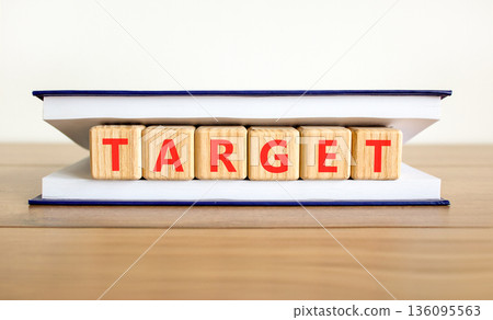 Target word symbol. Concept word Target on beautiful wooden blocks in beautiful book. Beautiful wooden table white background. Business target word concept. Copy space. Target word symbol. Concept word Target on beautiful wooden blocks in beautiful book. Beautiful wooden table white background. Business target word concept. Copy space. 136095563