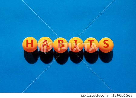 Habits support and help symbol. Concept word Habits on beautiful orange table tennis ping pong balls. Beautiful blue background. Business psychological habits support and help concept. Copy space. 136095565