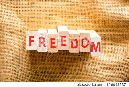 Freedom support symbol. Concept word Freedom on beautiful wooden blocks. Beautiful canvas background. Business freedom support concept. Copy space. 136095587