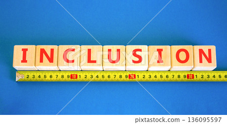 Inclusion symbol. Concept words Inclusion on beautiful wooden blocks. Beautiful blue background. Beautiful yellow ruler. Business support inclusion concept. Copy space. 136095597