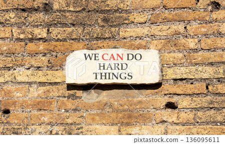 Support, help we can do hard things symbol. Concept words We can do hard things on beautiful marble sign plate. Beautiful brick wall background. Business we can do hard things concept. Copy space. Support, help we can do hard things symbol. Concept words We can do hard things on beautiful marble sign plate. Beautiful brick wall background. Business we can do hard things concept. Copy space. 136095611