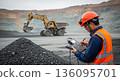 An engineer inspecting the quality of rare earth ore at an open-cut mine 136095701