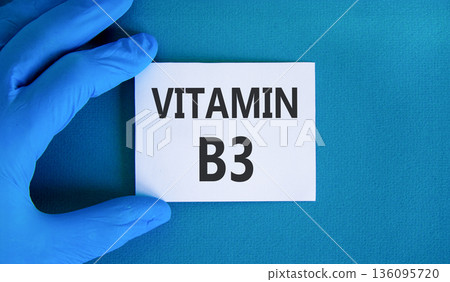 Vitamin B3 niacin symbol. Concept words Vitamin B3 on beautiful white card. Doctor's hand in blue medical glove. Beautiful blue background. Medical healthy lifestyle Vitamin B3 niacin concept. Vitamin B3 niacin symbol. Concept words Vitamin B3 on beautiful white card. Doctor's hand in blue medical glove. Beautiful blue background. Medical healthy lifestyle Vitamin B3 niacin concept. 136095720