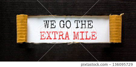 Support, help we go the extra mile symbol. Concept words We go the extra mile on beautiful white paper. Beautiful black paper background. Business we go the extra mile concept. Copy space. Support, help we go the extra mile symbol. Concept words We go the extra mile on beautiful white paper. Beautiful black paper background. Business we go the extra mile concept. Copy space. 136095729