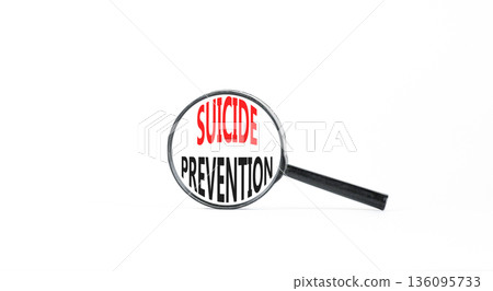 Suicide prevention symbol. Concept words Suicide prevention on beautiful magnifying glass. Beautiful white table white background. Psychological suicide prevention concept. Copy space. Suicide prevention symbol. Concept words Suicide prevention on beautiful magnifying glass. Beautiful white table white background. Psychological suicide prevention concept. Copy space. 136095733
