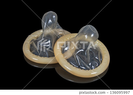Latex condoms on a dark background close up 136095997