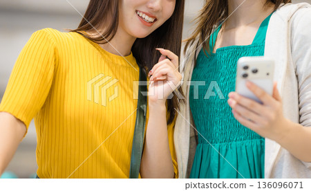 Two women browsing smartphones _■Photography cooperation: Kansai International Airport (KIX) Two women browsing smartphones _■Photography cooperation: Kansai International Airport (KIX) 136096071