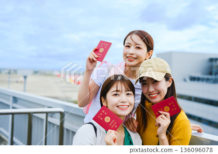Women showing their passports at the airport. Photo courtesy of Kansai International Airport (KIX) Women showing their passports at the airport. Photo courtesy of Kansai International Airport (KIX) 136096078