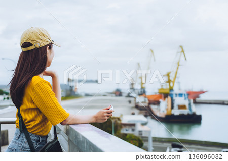 Back view of a woman looking at the fantastic harbor Back view of a woman looking at the fantastic harbor 136096082