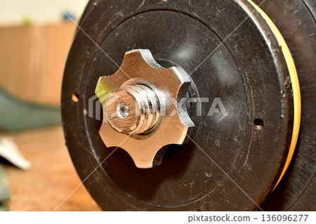 Fastening a collapsible dumbbell with a nut. Fastening a collapsible dumbbell with a nut. 136096277