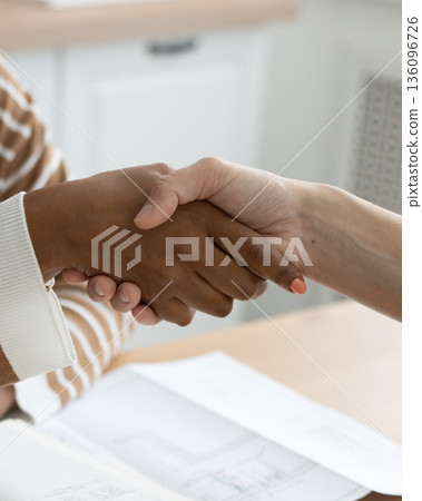 handshake between two people, conclusion of contract for sale of real estate. handshake between two people, conclusion of contract for sale of real estate. 136096726