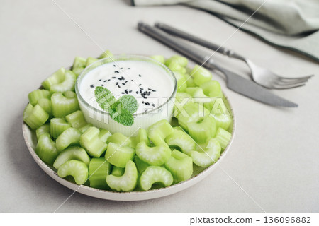 Chopped celery stalks with greek yogurt 136096882