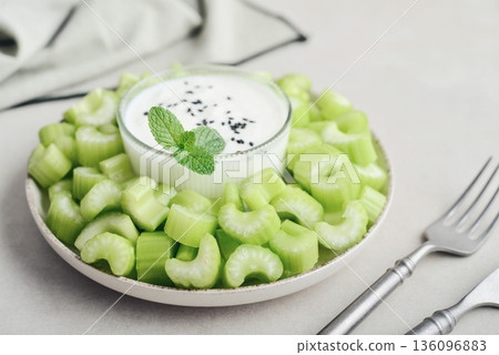 Chopped celery stalks with greek yogurt Chopped celery stalks with greek yogurt 136096883