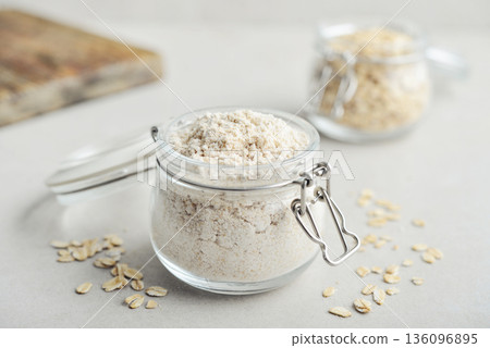 Oat flour in glass jar Oat flour in glass jar 136096895
