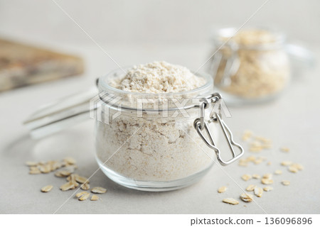 Oat flour in glass jar Oat flour in glass jar 136096896