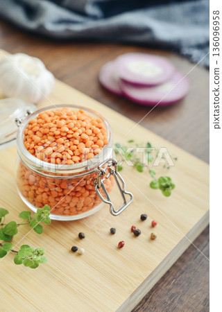 Raw dry red lentils with spices and herbs in a glass jar Raw dry red lentils with spices and herbs in a glass jar 136096958