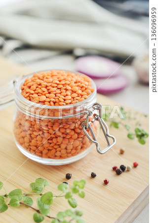 Raw dry red lentils with spices and herbs in a glass jar Raw dry red lentils with spices and herbs in a glass jar 136096959