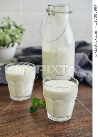Two glasses of Turkish traditional drink ayran, kefir or buttermilk Two glasses of Turkish traditional drink ayran, kefir or buttermilk 136096994